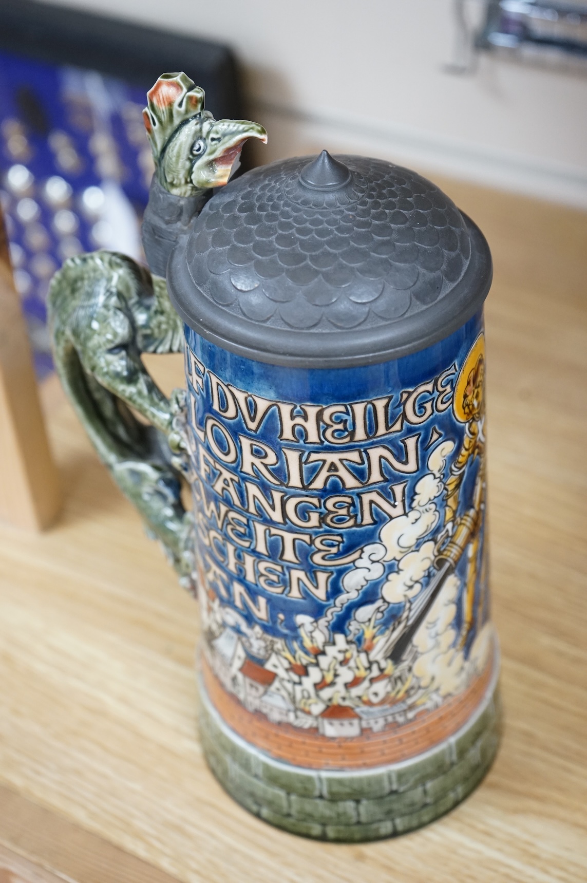 A Mettlach ‘ St Florian‘ stoneware stein, 27cm